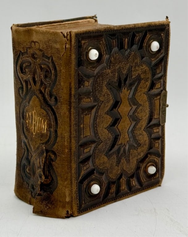 Antique Leather Bound Photo Album w. Photos: Antique leather bound photo album with photos. Each page filled, 50 total tintypes. Album in heavily aged condition. Approximately 5.5"h x 4"w. Photos are considered part of the condition and descript