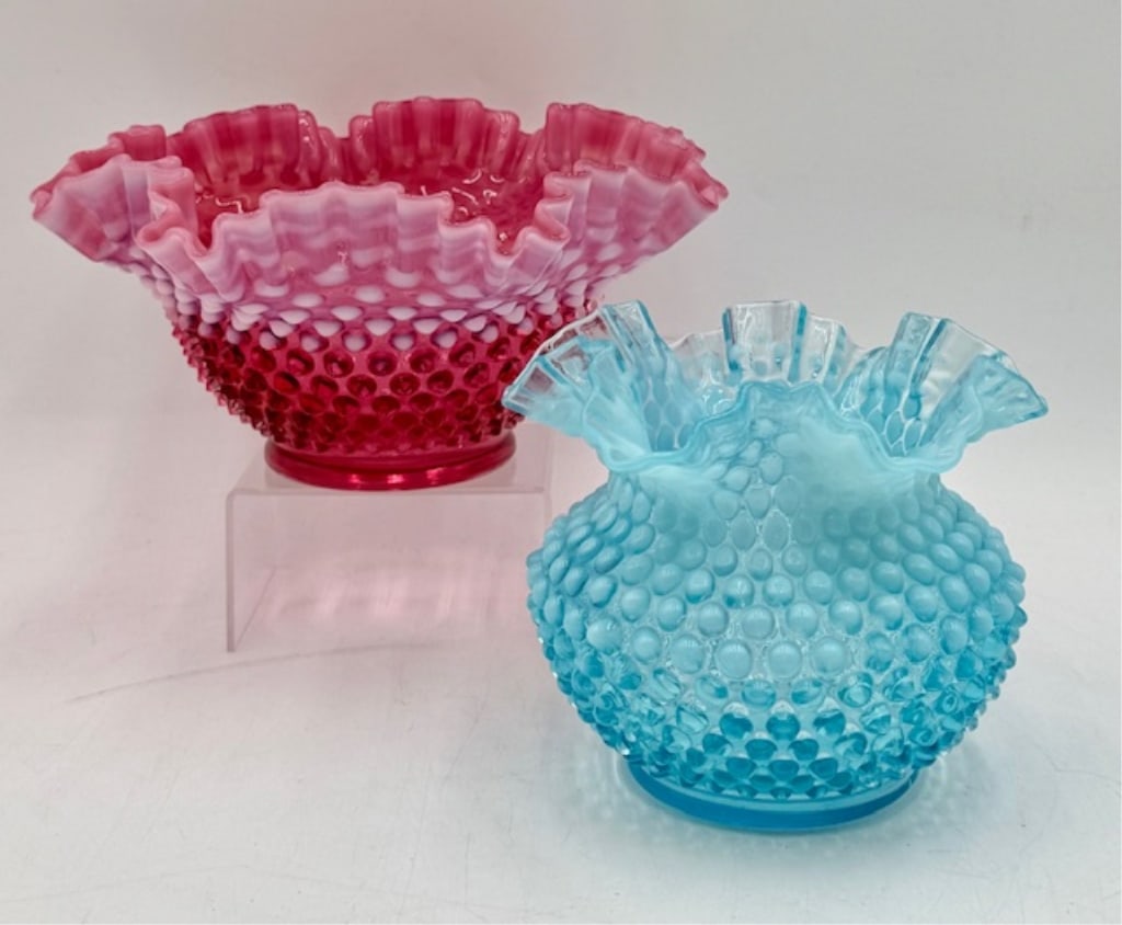 Pair of Fenton Hobnail Ruffled Top Bowls: Pair of Fenton hobnail ruffled top bowls. Includes 4.5"h x 9.25"w cranberry glass bowl and 5.25" x 6"w blue glass bowl. Blue bowl has some black dots present towards top. Photos are considered part of