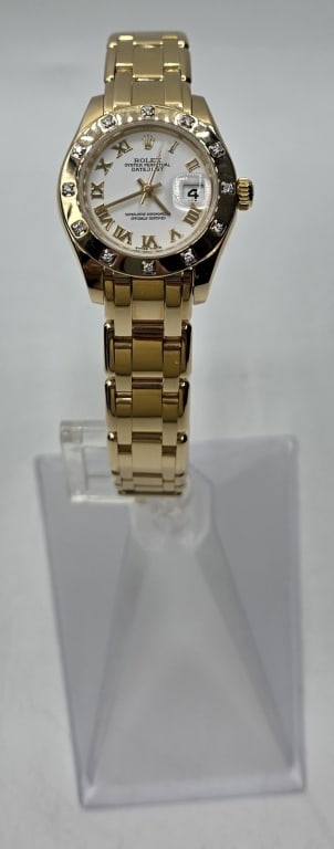 Ladies 18k Rolex Pearlmaster 29mm: Ladies 29mm Rolex Pearlmaster in 18k yellow gold with factory original 12 stone diamond bezel and Roman numeral dial. 2001. Comes with box. Photos are considered part of the description and