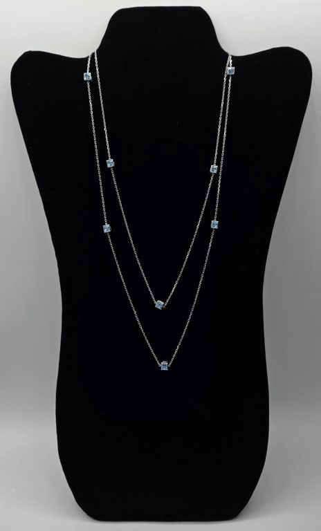 Gucci 18k 42" Logo Cube Necklace - 17.92g TW: Beautiful Gucci 18k white gold 42" logo cube necklace. 10 Cubes features Gucci logo and blue topaz stone. Oval link chain with push button clasp. Approximately 17.92g TW. Photos are considered part of