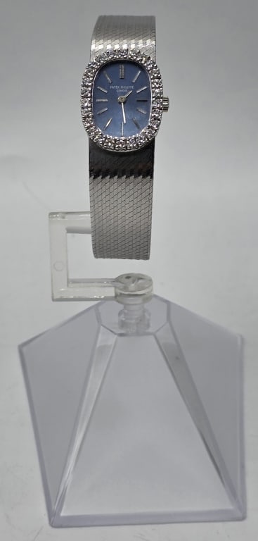 Ladies 18k Patek Philippe Diamond Wrist Watch: Ladies 18k white gold Patek Philippe diamond wrist watch. Features diamond bezel and ellipse blue dial. Integrated herringbone design bracelet with adjustable double latch closure. Manual wind. Approx