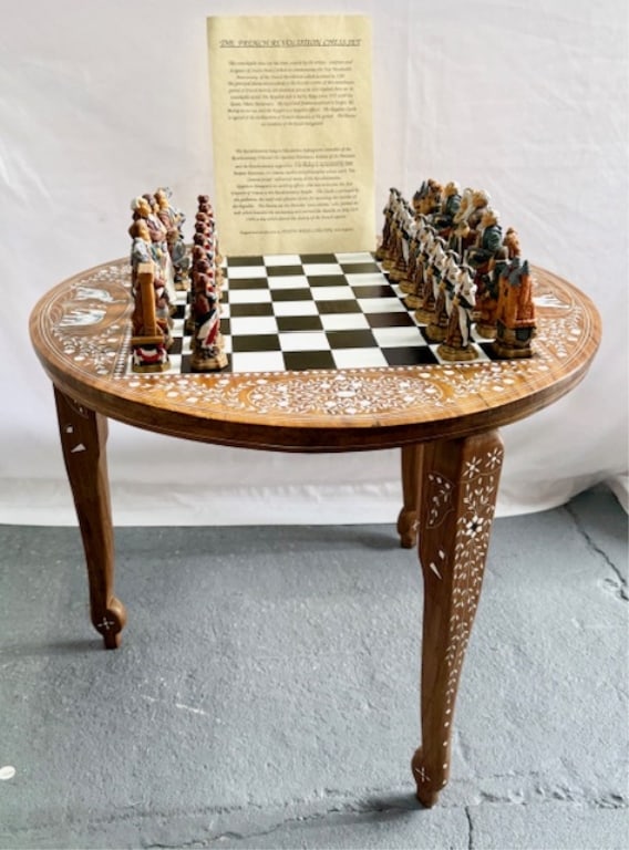 Inlaid Chess Table & French Revolution Chess Set: Beautiful inlaid chess table and French Revolution chess set. Round table features inlaid mother of pearl accents on top and along legs. 32 Piece French Revolution design chess piece set