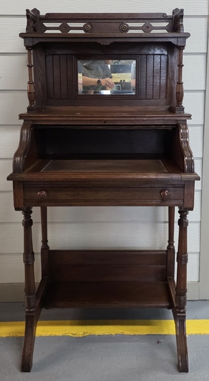 Antique Eastlake Style Ladies Roll Top Desk: Antique Eastlake style ladies roll top writing desk. Desk features single pull drawer, carved details, turned spindle supports, and small top mirror. ln good condition for age with some wood