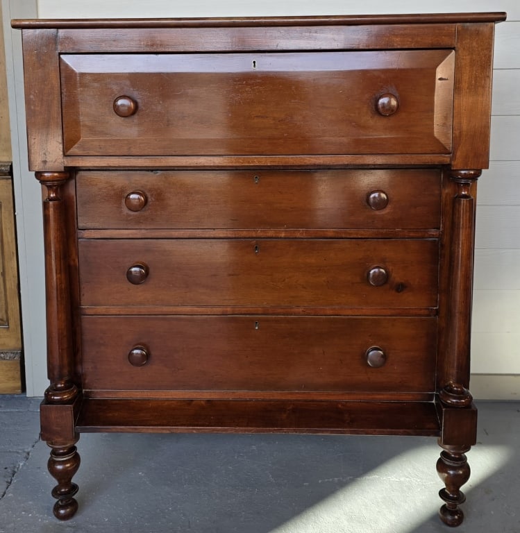 Antique American Empire Style Chest of Drawers: Antique American Empire style cherry wood chest of drawers. Dresser features 4 pull drawers, round wooden knobs, and spindle column front accents. In good condition for age with some scratches