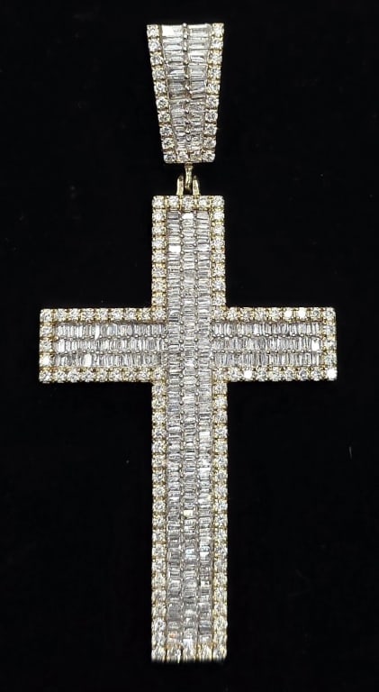 10K Diamond Cross Pendant - 13.37g TW: 10k Dadwani diamond cross pendant. Cross features 3 rows of baguette diamonds outlined with 4 prong set round diamond and pendant bail features 2 rows of baguette diamonds outlined with 4 prong