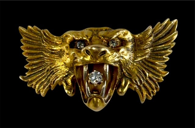 Antique 14k Diamond Lion's Head Brooch - 19.3g TW: Antique 14k yellow gold and diamond lion's head brooch. May have originally been a stick pin. Features diamond eyes and one in mouth with textured mane that extends into wing like flourishes.