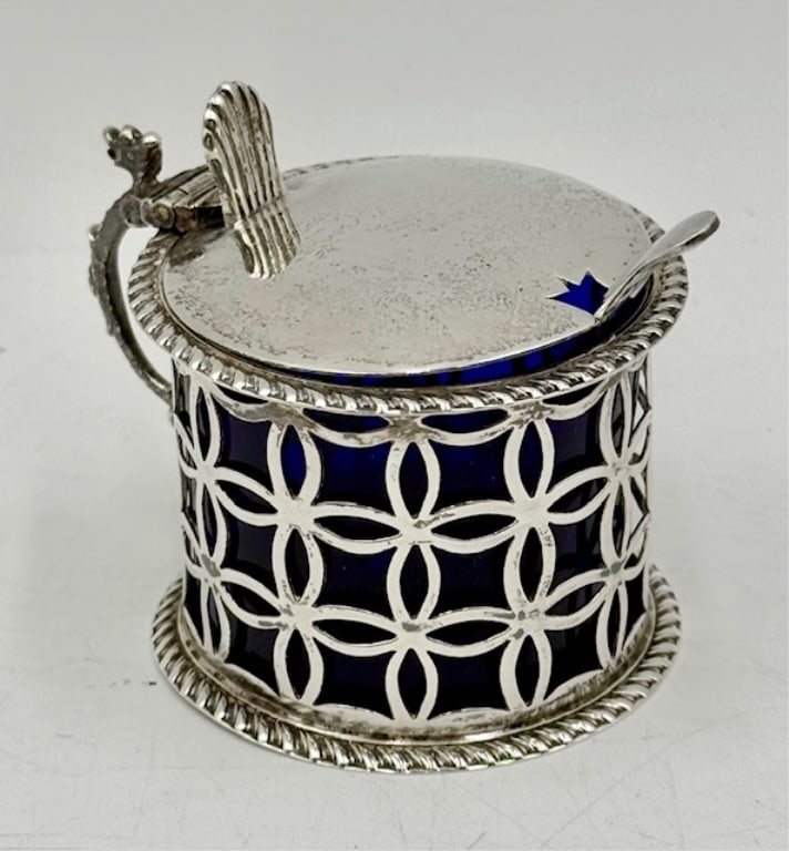 William Hutton & Sons Sterling Mustard Pot: Antique William Hutton & Sons Ltd. sterling silver mustard pot. Mustard pot features ornate pierced sterling silver body with cobalt glass insert. Cobalt insert does have crack line present. Sterling