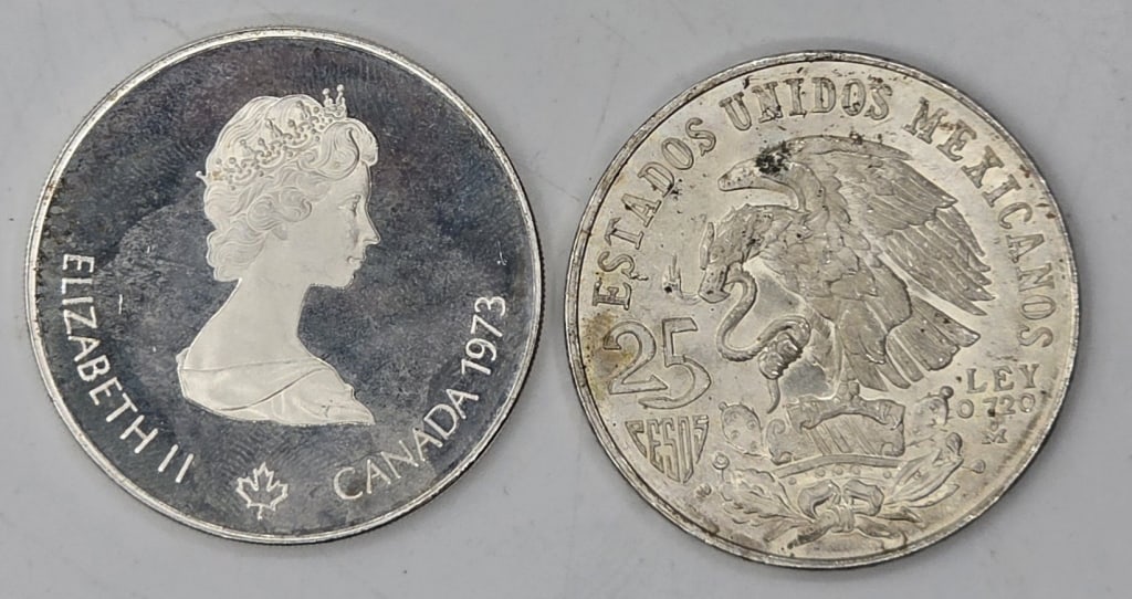 2 Commemorative Olympic Silver Coins- 1.6oz TW: Collection of two commemorative silver coins. Includes 25 peso commemorative coin issued for the 19th Summer Olympics and 1973 Canadian 5 dollar silver commemorative coin issued for the 1976 Montreal