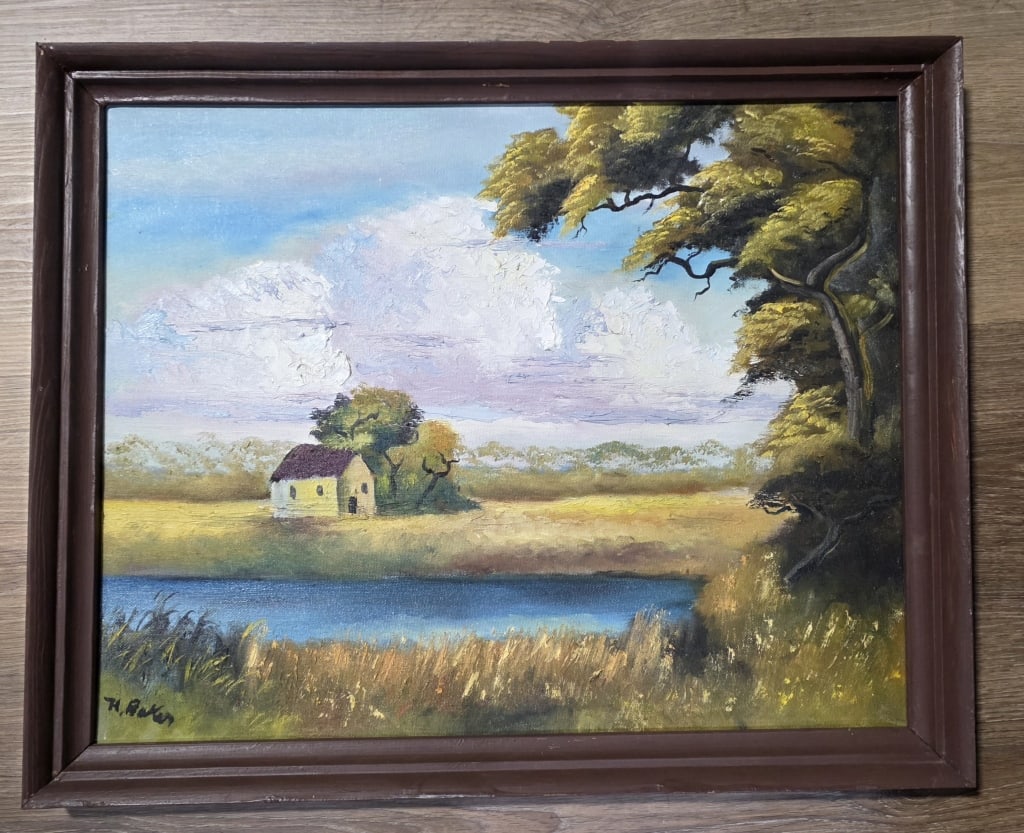 Hezekiah Baker Signed original Highwaymen Painting: Hezekiah Baker, an original Florida Highwaymen artist, signed painting. Depicts a small house situated in a yellow field with tall grass and a body of water in the foreground. Oil on board in wood fra
