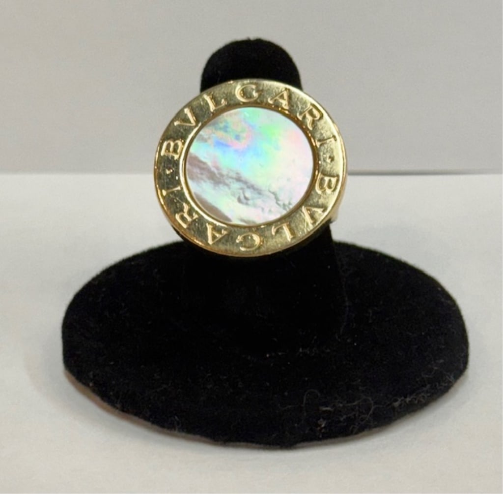Ladies Bvlgari 18k Mother of Pearl Ring - 15.24g: Ladies Bvlgari 18k yellow gold mother of pearl ring. The signature design features double logo engraved gold border and mother of pearl bezel. Approximately 15.24g TW and size 6.75. Photos are conside