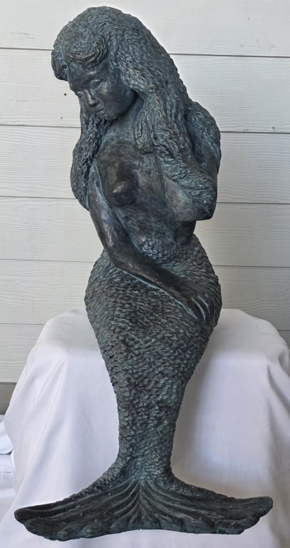Concrete Sitting Mermaid Garden Statue: Precast concrete sitting mermaid statue. Statue features heavily detailed tail and features. Painted bronze patina. Approximately 27"h. Photos are considered part of the condition and description. 419