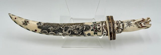 Vintage Carved Chinese Dragon Knife & Sheath: Vintage carved Chinese dragon knife and sheath. Believed to be bone or other bone like material. The intricate carvings include a dragon motif and dragon head handle. Approximately 14.5"l. Photos are
