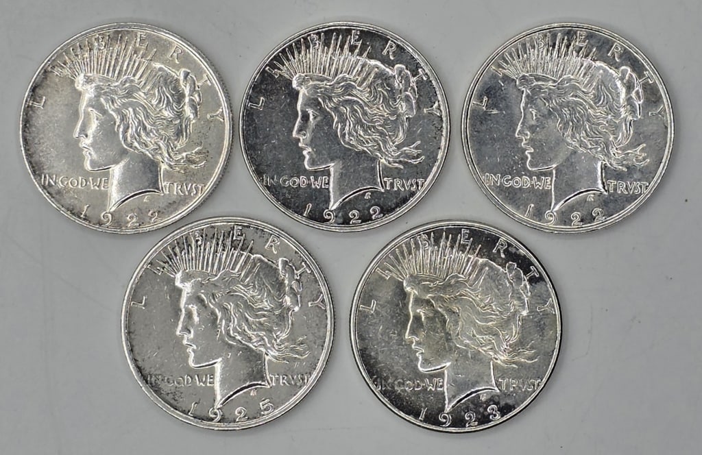 5 Assorted Silver Morgan Dollars - 4.7oz TW: Collection of 5 assorted silver Morgan Dollars. Includes (3) 1922, 1923, and 1925. Approximately 4.7oz TW. Photos are considered part of the condition and description. R