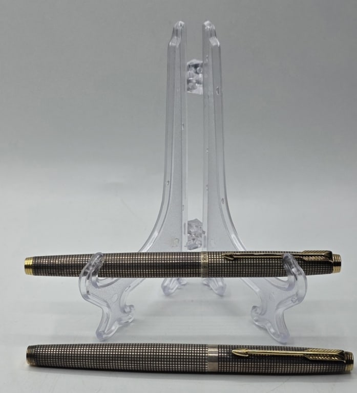 Pair Parker 75 Cisele S.S. Gold Nib Fountain Pens: Pair of vintage sterling silver Parker 75 Cisele writing instruments. Includes a two fountain pens featuring the distinctive grid-like "Cisele" pattern and 14k gold nibs. Approximately 5" long. Photos