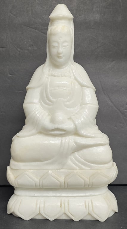 Chinese Alabaster Kwan Yin Sculpture: Chinese alabaster Kwan Yin Buddha sculpture. Features seated Kwan Yin in a meditative pose on a lotus base. Two pieces total. Approximately 12.5"h. Photos are considered part of the condition and