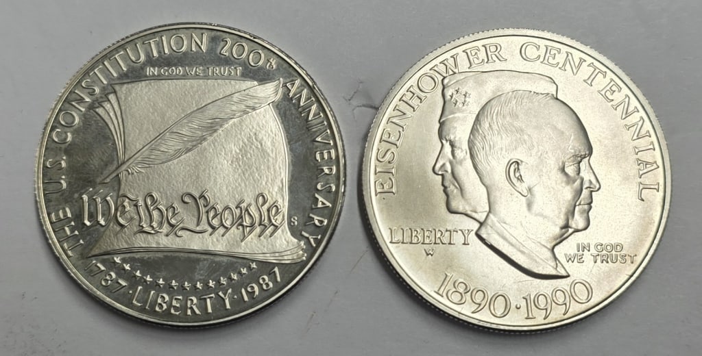 Pair of Silver Commemorative Coins - 1.9oz TW: Pair of silver commemorative coins. Includes 1987 U.S. S Constitution Bicentennial silver dollar and 1990 Eisenhower Centennial silver dollar. Approximately 1.9oz TW. Photos are considered part of