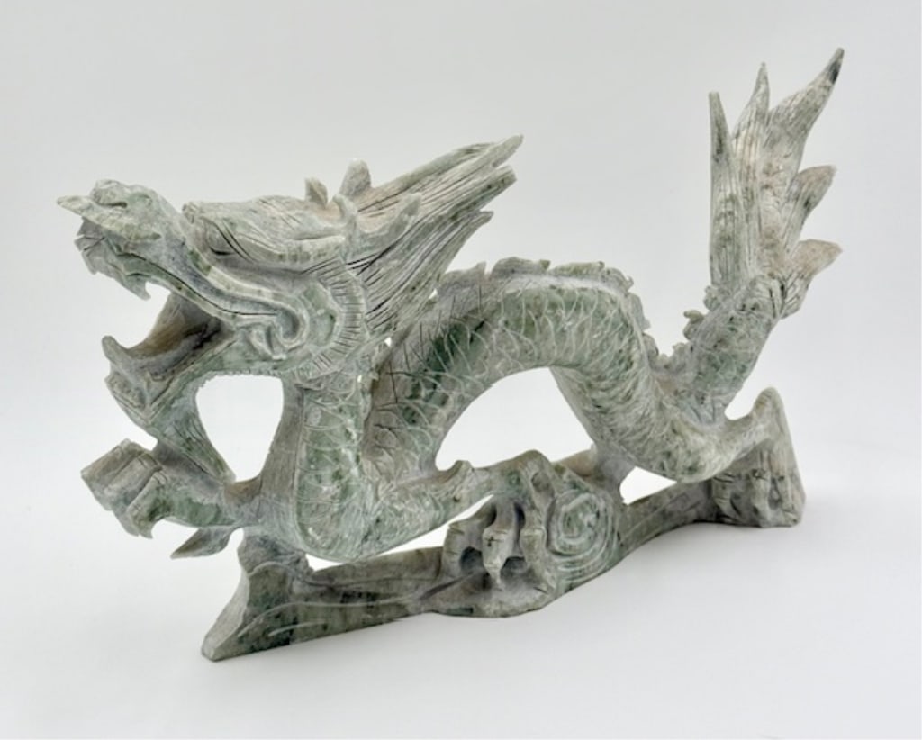 Vintage Carved Serpentine Jade Dragon: Vintage carved serpentine jade dragon. One spine on back chipped. Approximately 8"h x 14.5"l x 2.75"w. Photos are considered part of the condition and description. 618-2