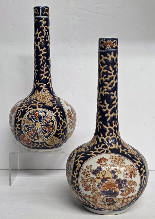 Pair of Japanese Imari Porcelain Bottle Vases: Pair of Japanese Imari porcelain bottle vases. Vases feature traditional Imari color palette of underglaze blue, iron red, and gold and floral motif. Approximately 9.5"h. Photos are considered part of