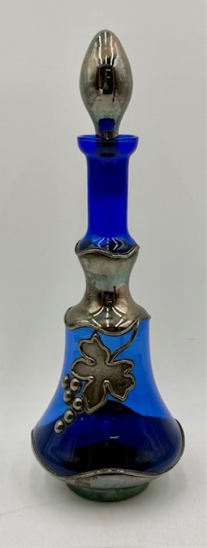 Vintage Italian Cobalt & Silver Overlay Decanter: Vintage Italian cobalt glass decanter. Decanter features beautiful cobalt body with decorative silver overlay grape leaf and grapes and silver stopper. Some wear and tarnishing to silver. No chips or