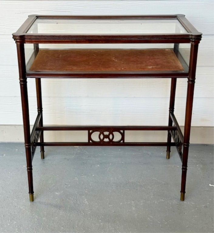 Vintage Mahogany Display Case Table: Vintage mahogany display case table. Table features glass cabinet with hinged glass top and sides and velvet lined bottom interior. Some light staining present on velvet. Brass caps on legs. Some wood