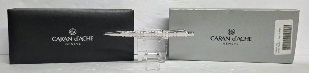 Collectible Caran d'Ache Ecridor Rotation Pencil: Collectible Caran d'Ache Ecridor Rotation writing pencil. Features irregular engraved shapes that follow a circular path around the hexagonal body. Uses a high precision push button mechanism with 0.7