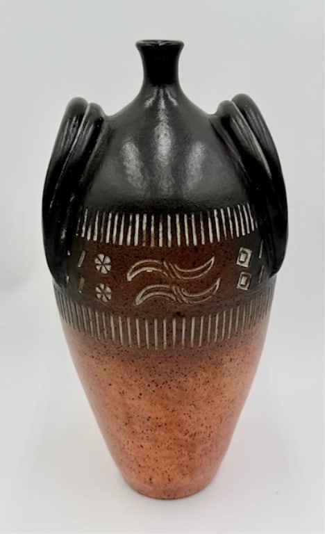 Vintage Studio Art Pottery Vessel: Vintage studio art pottery vessel. Shaped like an amphora. Features faux handles, intricate carvings, and a speckled ombre finish in black and brown. In excellent condition with no chips or cracks. Ap