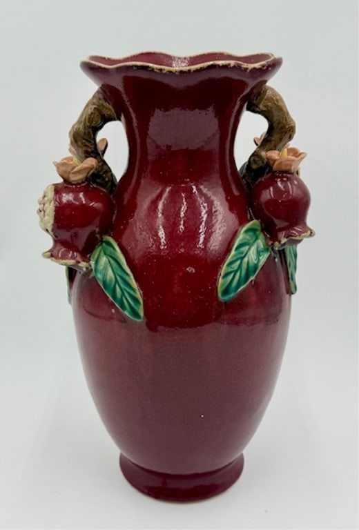 Vintage Sang de Boeuf Vase: Vintage Sang de Boeuf vase. Chinese flambe pottery. Vase features sculpted pomegranate fruits and green leaves on the handles. In excellent condition with no chips or cracks. Approximately 13"h x 7.25