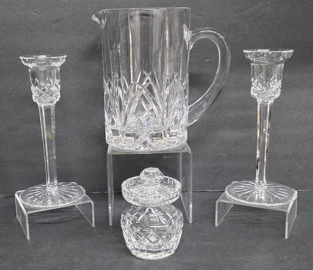 Assorted Waterford Crystal Lismore Collectibles: Collection of Waterford Crystal collectibles in the Lismore pattern. 4 Pieces total. Includes pair of 7.25" candlesticks, 7" pitcher, marked Marquis, and 4" mustard jar. Nicks present in mustard jar.