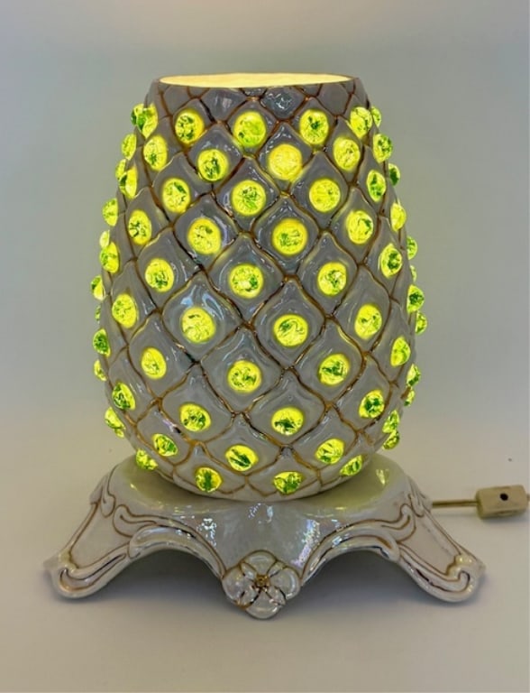 Vintage Mid Century Ceramic Pineapple Table Lamp: Vintage mid century ceramic pineapple table lamp. Lamp features pineapple shaped ceramic body with a decorative pedestal base and green accent marbles that glow when lit. Some marbles chipped. In work