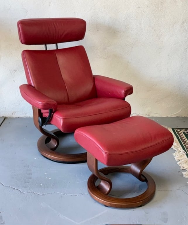 Ekornes Taurus Stressless Chair & Ottoman: Ekornes Taurus stressless chair and ottoman. Set is finished in a deep red leather and features a wooden "Classic" base. Norwegian made. Some minor rub/nicks in leather. Chair approximately 39"h