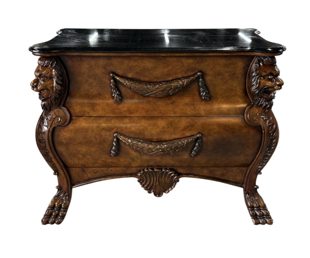Vintage Lion Head Marble Top Chest of Drawers: Vintage chest of drawers. Features black marble top and heavily carved details including lion heads, swag rope pull handles, paw feet, and lower shell accent. Two drawers. Some minor wood chips