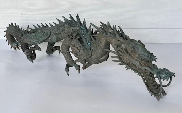 Antique Japanese Bronze Dragon Sculpture: Antique Japanese bronze dragon sculpture. Features highly detailed scales, horns, and claws. Cast bronze with an oxidized green patina. Heavy. Approximately 8"h x 32"l x 9"w. Photos are