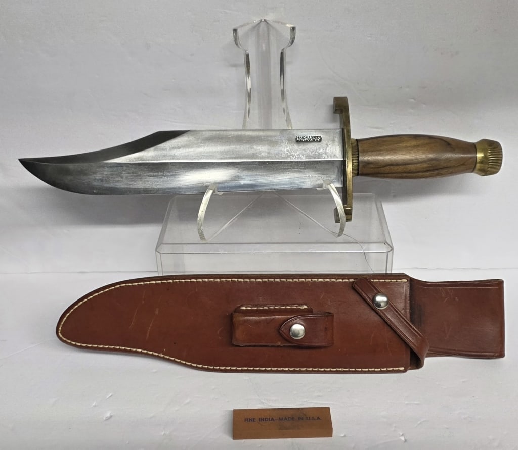 Randall Made Model 12 Smithsonian Bowie Knife: Randall Made Model 12 "Smithsonian" bowie knife. Knife features lugged brass hilt, scalloped collar, concave walnut handle, and scalloped brass butt cap. Accompanied by model A Randall made leather sh