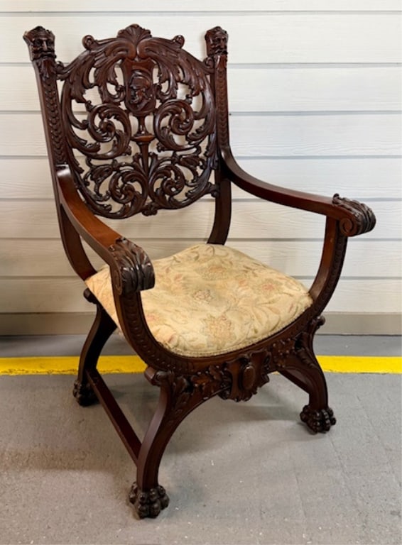 Antique Horner Style Carved Arm Chair: Antique Horner style carved arm chair. Features a deep mahogany finish with intricate hand carvings and figural details. Paw feet. Upholstered seat. In good condition for age with some nicks, chips, a