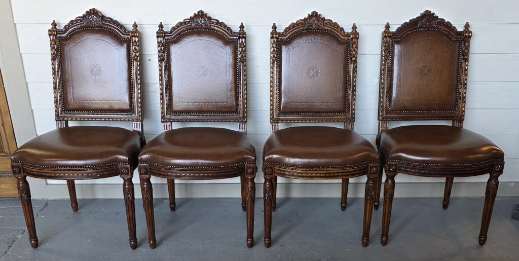 Theodore Alexander Grand Set of Chairs: Theodore Alexander grand set of chairs. Chairs feature ornately carved walnut frames and rich leather upholstery accented with dark brass nail heads. Made in Vietnam. 4 Total. Approximately 42.5"h x 2
