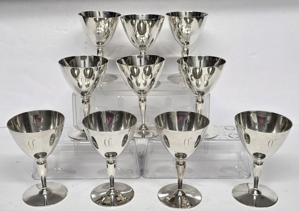 Tiffany & Co. Sterling Cocktail Cups - 39.31oz: Set of 10 art deco Tiffany & Co. sterling silver cocktail cups. Monogramed. Bottom marked 18885 Makers 16951. One base slightly bent. Approximately 5.5"h and 39.31oz CTW. Photos are considered part of