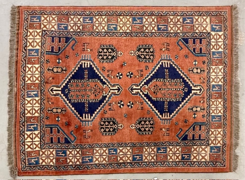 Na' In Handmade Wool Carpet: Na' In hand made wool carpet. Features tan, orange, and blue tones. In good condition. Approximately 60" x 82". Photos are considered part of the condition and description. 119-2