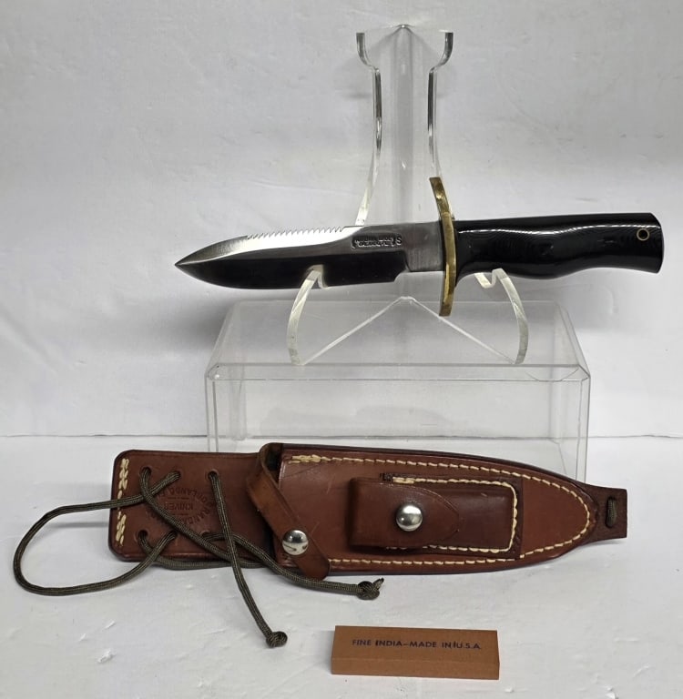 Randall Made Model 15 Airman Knife: Randall Made Model 15 Airman knife. Knife features saw teeth, stainless blade, straight oblong brass hilt, and black Micarta finger grip handle. Extra heavy wide tang extends through a channel in the
