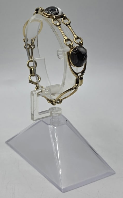 Vintage 14k Equestrian Bracelet - 20.31g: Vintage 14k equestrian bracelet. Bracelet features painted? images of a horse and dog. Snaffle bit designed links with stirrup like charms. Approximately 7.5" long and 20.31g TW. Photos are considered