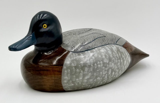 Artist Signed Hand Crafted Bluebill Duck Decoy: Handcrafted Bluebill wooden duck decoy. Artist signed, Gene Malin, 1997. Duck features hand painted body and glass? eyes. Approximately 6"h x 12"l x 6.25"w. Photos are considered part of the condition