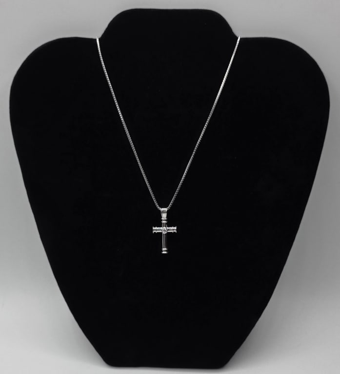 18k Theo Fennell Cross Necklace - 9.26g CTW: Theo Fennell 18k white gold cross pendant and chain. Part of the "Tod" or "Crosses" collection. Features a central diamond. Cross approximately 1"h x .5"w and chain approximately 18" long.