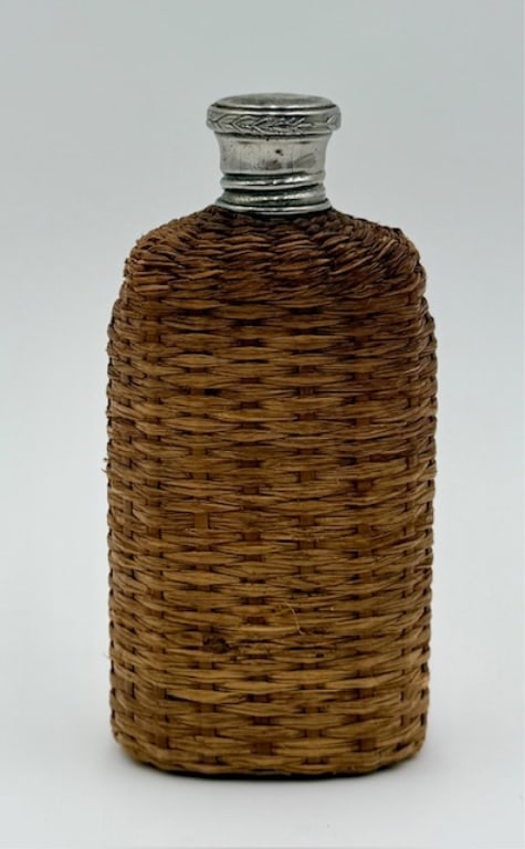Vintage Wicker Wrapped Flask: Vintage hand woven wicker wrapped flask. Silver metal cap. In good condition for age with no visible chips or cracks. Approximately 5"h. Photos are considered part of the condition and description. 61
