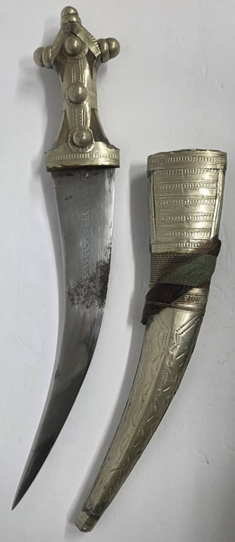 Wahabite Jambiya Curved Dagger: Wahabite Jambiya curved dagger. Double-edged steel blade, some rust and wear present. Wood hilt encased in metal with ornamental studs. Scabbard is decorated with intricate motif. Approximately 20"lon