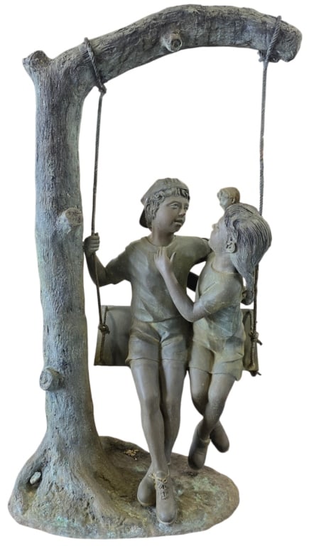 Large Bronze "Boy & Girl" on Swing Outdoor Statue: Large outdoor bronze sculpture titled "Boy and Girl on a Swing". Large scale bronze depicts a nostalgic scene of two children sharing a playful moment on a swing suspended from a tree branch. Hole pre
