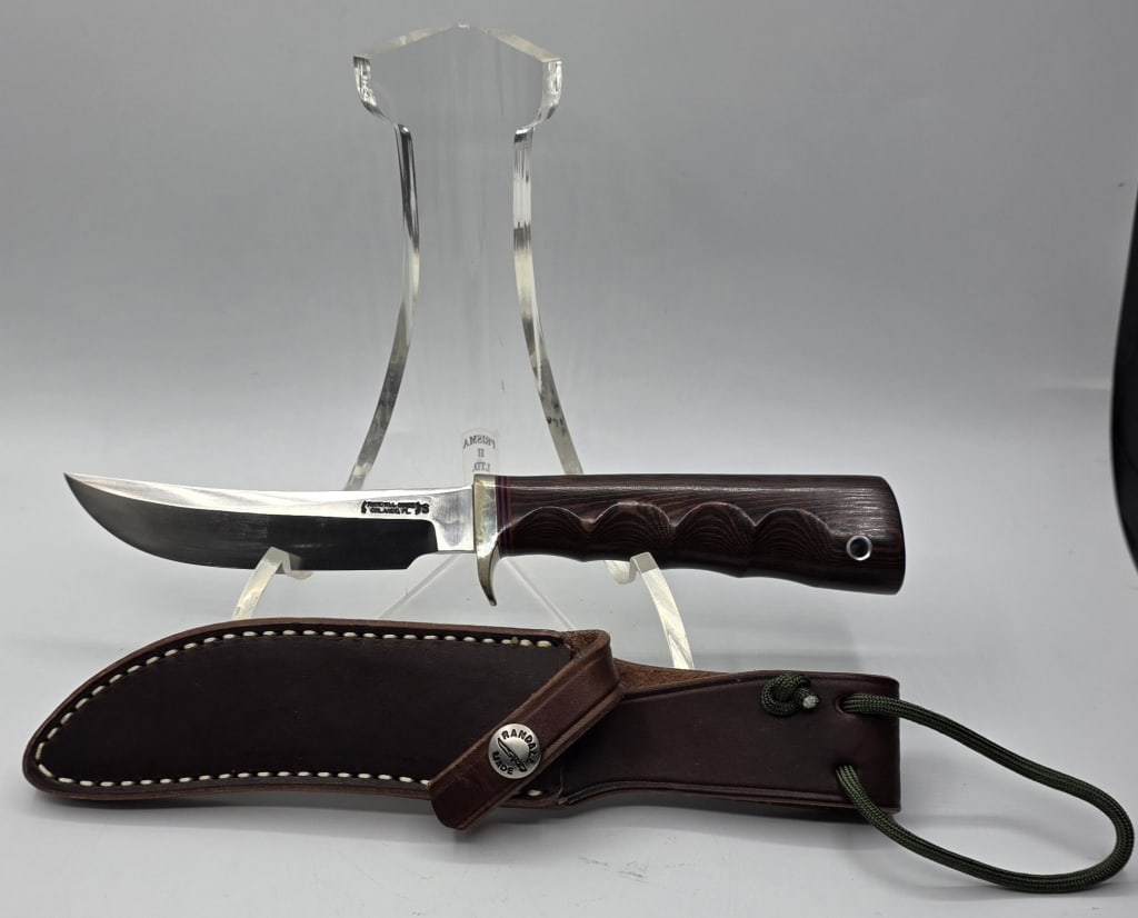 Custom Randall Made Model 4 Small Game Skinner: Custom Randall Made Model 4 Small Game Skinner knife. Knife features thumb notch on top of blade in front of single brass hilt, maroon micarta handle, and stainless steel blade. Accompanied by model B
