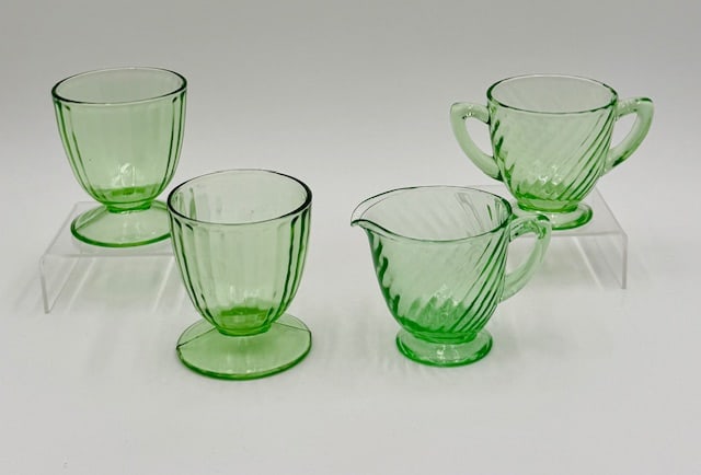 Vintage Uranium Glass Collectibles: Vintage uranium glass collectibles. Includes pair of 3.25" cups, 2.75" sugar cup, and 3" creamer. Small glass imperfection present in one cup. Photos are considered part of the condition and descripti