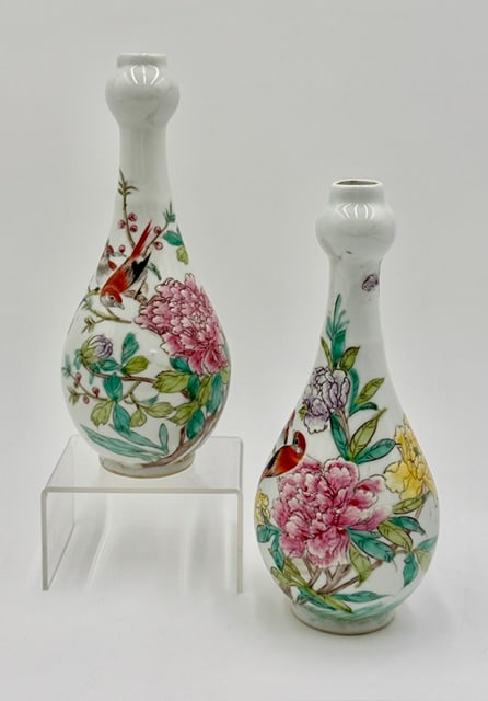 Pair of Chinese Famille Rose Porcelain Vases: Pair of Chinese Famille Rose porcelain vases. Both feature traditional motifs of blossoming flowers and birds. Stamped on bottoms. In excellent condition with no chips or cracks present. Approximately