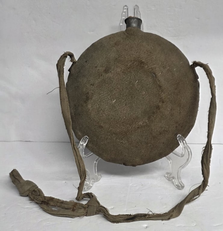 Antique U.S. Model 1858 Smooth Side Canteen: Antique U.S. Model 1858 "Smooth Side" canteen. American Civil War era. Made of tinned sheet iron covered in canvas. Features a pewter spout with a cork and a sling for carrying. In normal condition