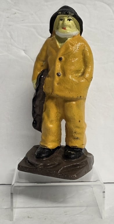 Vintage "Old Salty" Cast Iron Doorstop: Vintage "Old Salty" cast iron doorstop. Featuring a fisherman wearing a yellow raincoat and holding a fishing net. Approximately 6.5"h. Photos are considered part of the condition and description. 508