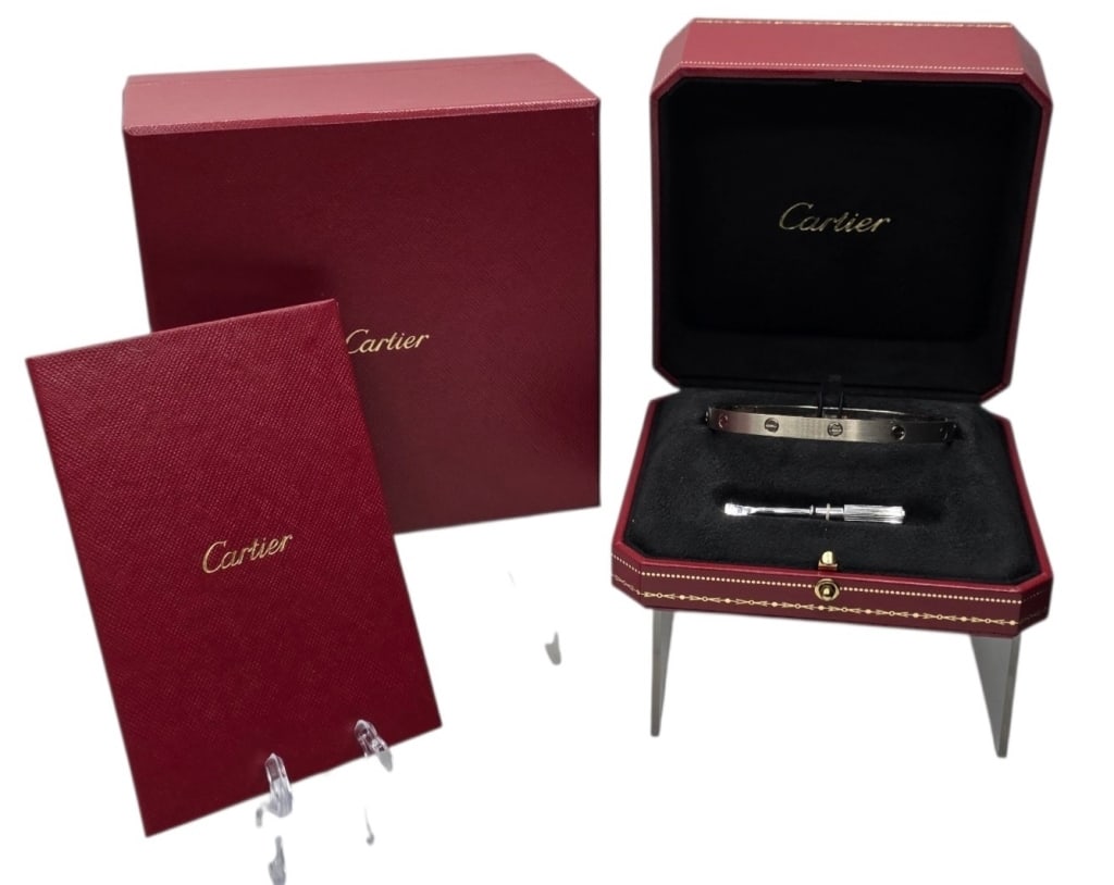 18k Cartier White Gold Love Bracelet: 18k White gold Cartier Love bracelet. Classic model. Serial number XKM950. Near new 2024 example with full original packaging. Authenticated and in excellent condition. Small bend present near screw. 